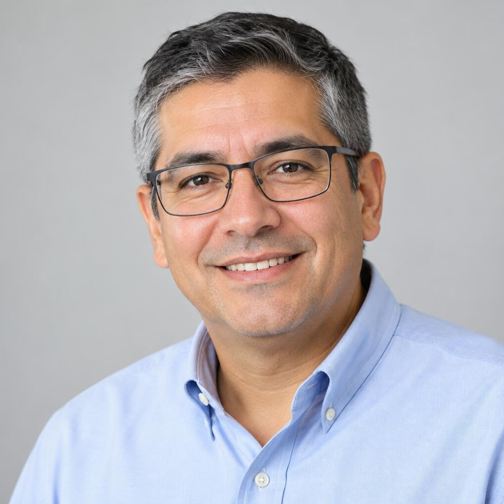 Portrait of a Latino man in his forties with glasses, events coordinator