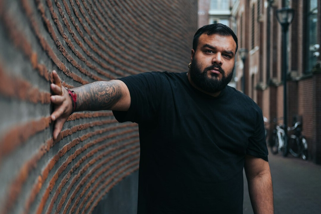 Portrait of a Latino man in his late twenties with a beard, football journalist