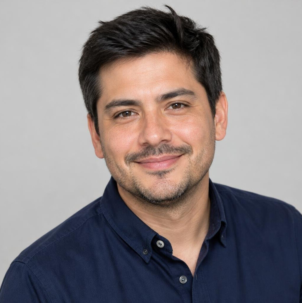 Portrait of a Latino man in his thirties with short dark hair and a navy shirt