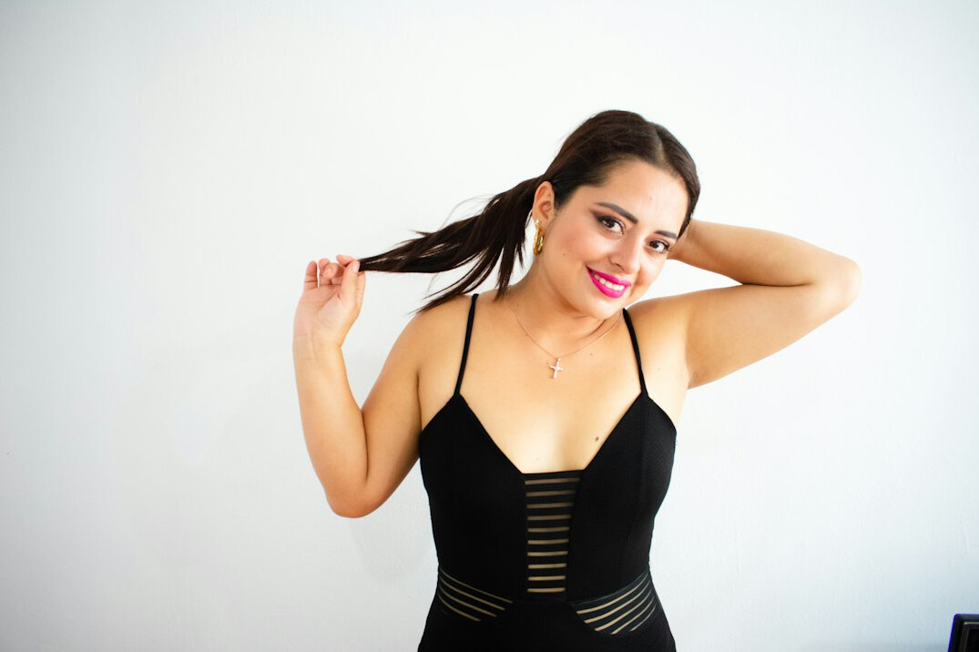 Portrait of a smiling Latina woman in her twenties with a ponytail